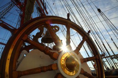 background for sea travel - the old wheel and rigging